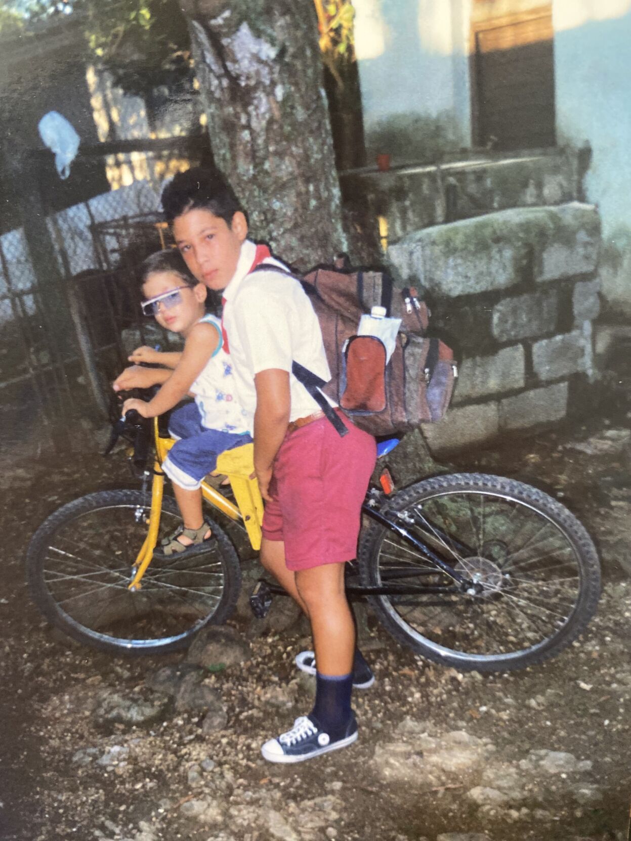 Victor and Vitin Medaros on the bike they took to school